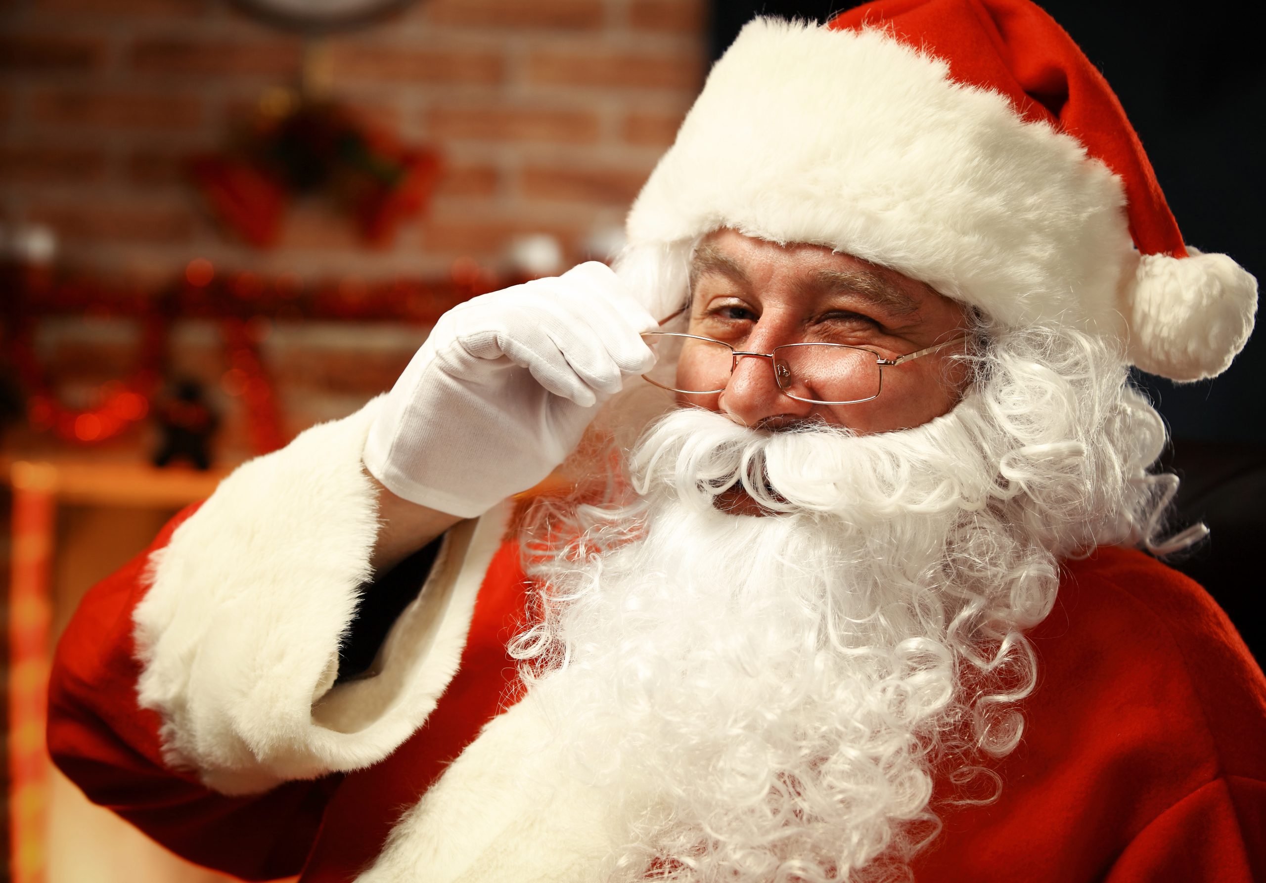 Portrait of happy Santa Claus holding Christmas letter